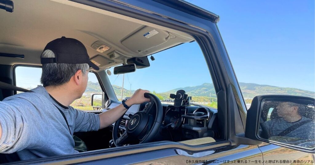 スズキジムニーJB64(2023年式)を運転する筆者が九州の春空の下で自撮りした写真