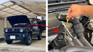 現役オーナーが自宅駐車場で愛車のスズキ・ジムニーJB64のボンネットを開け、エンジンオイルレベルゲージを点検している様子。